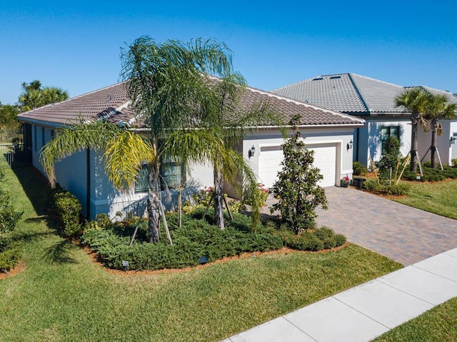 mediterranean / spanish home with a garage and a front yard