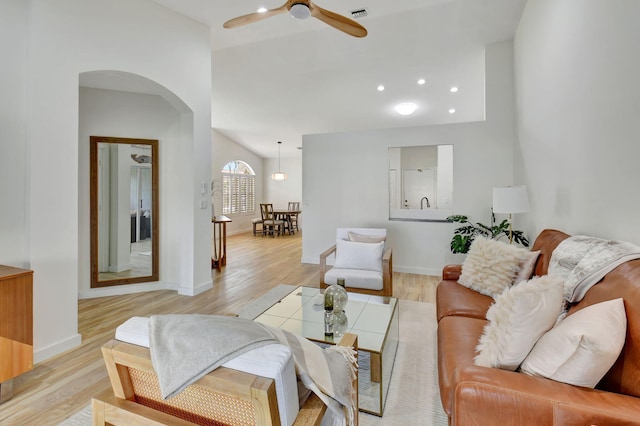 living room featuring ceiling fan and light hardwood / wood-style floors