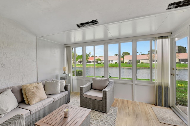 sunroom / solarium with a water view