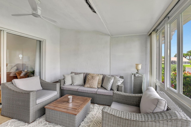 sunroom / solarium featuring a wealth of natural light and ceiling fan