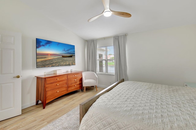 bedroom featuring ceiling fan, light hardwood / wood-style floors, and lofted ceiling