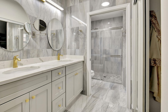 bathroom with toilet, vanity, tile walls, and walk in shower