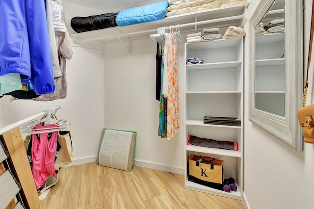 spacious closet featuring hardwood / wood-style floors