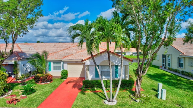 view of front of house featuring a front yard and a garage