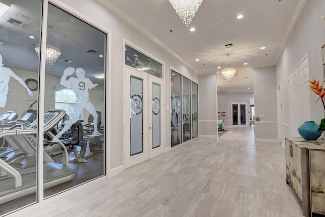 corridor with ornamental molding, french doors, and a notable chandelier