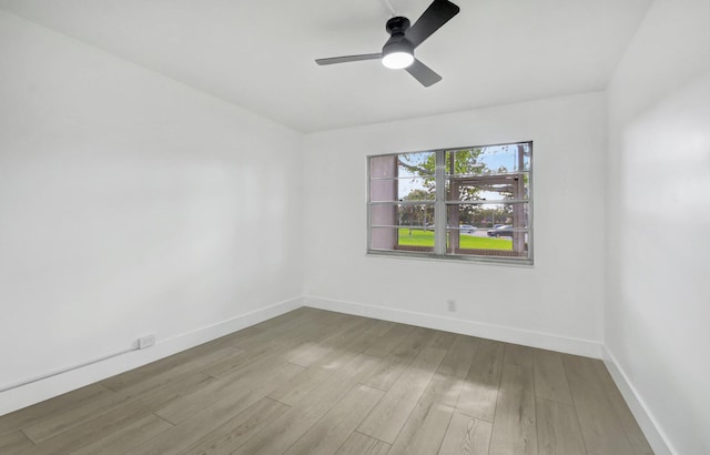 spare room with hardwood / wood-style floors and ceiling fan