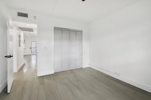 unfurnished bedroom featuring light hardwood / wood-style floors and a closet