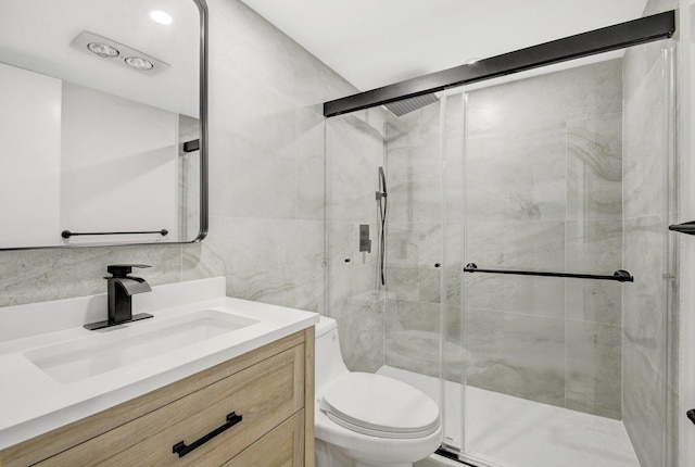 bathroom with tasteful backsplash, a shower with door, vanity, and toilet