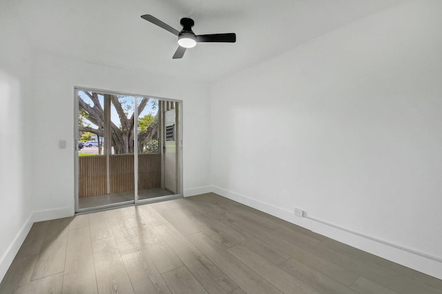 spare room with hardwood / wood-style floors and ceiling fan