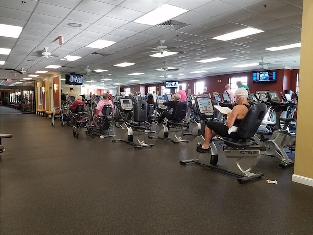 gym featuring ceiling fan and a drop ceiling