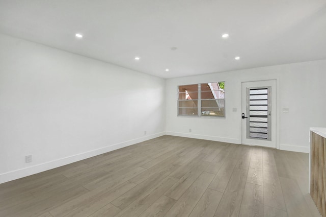 unfurnished room with light wood-type flooring