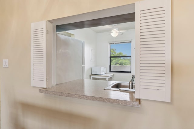 kitchen featuring sink, refrigerator, and ceiling fan