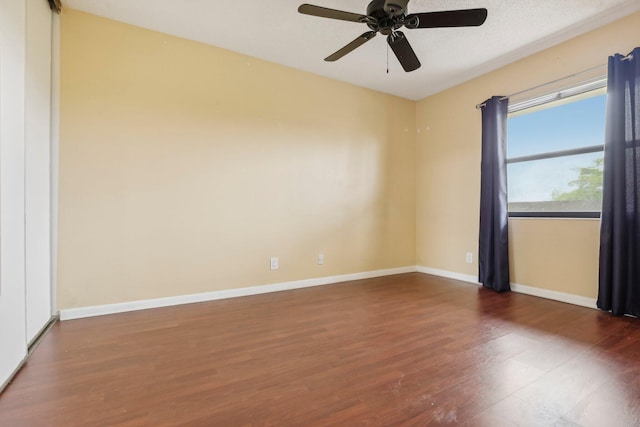 unfurnished room with ceiling fan and dark hardwood / wood-style floors