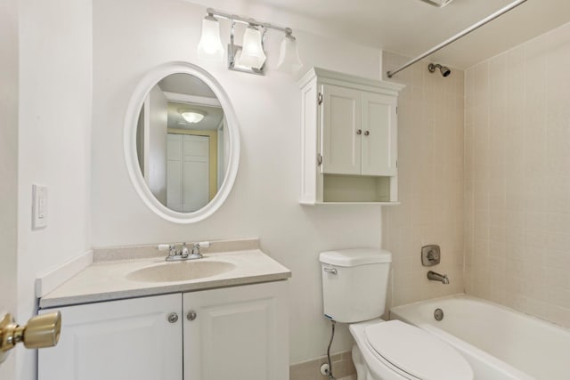 full bathroom with tiled shower / bath, vanity, and toilet