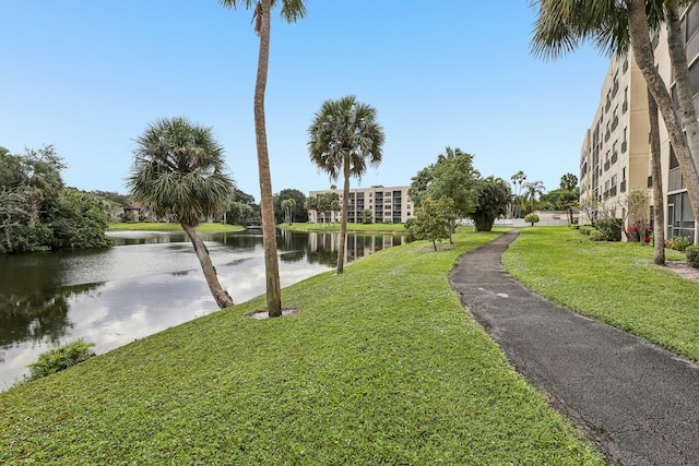 view of community with a lawn and a water view