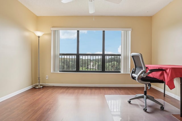 home office featuring a textured ceiling, ceiling fan, and wood-type flooring