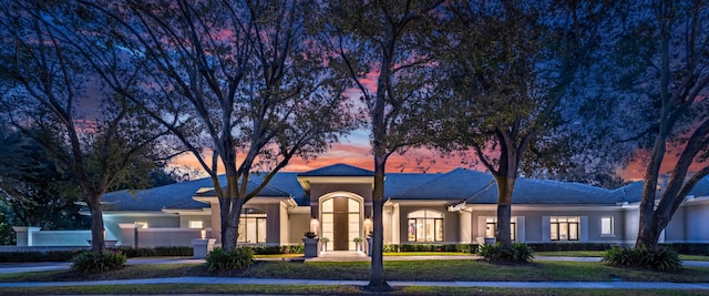 ranch-style home with a lawn