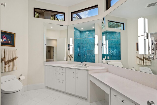 bathroom with toilet, vanity, and a shower with door