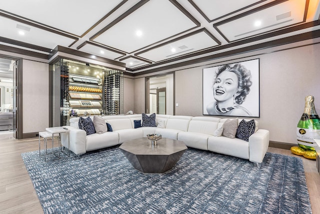 living room with hardwood / wood-style flooring, crown molding, and coffered ceiling