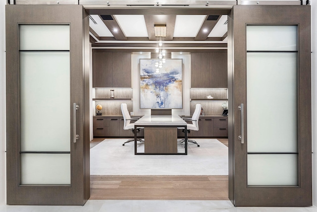 dining space with beam ceiling and light hardwood / wood-style flooring