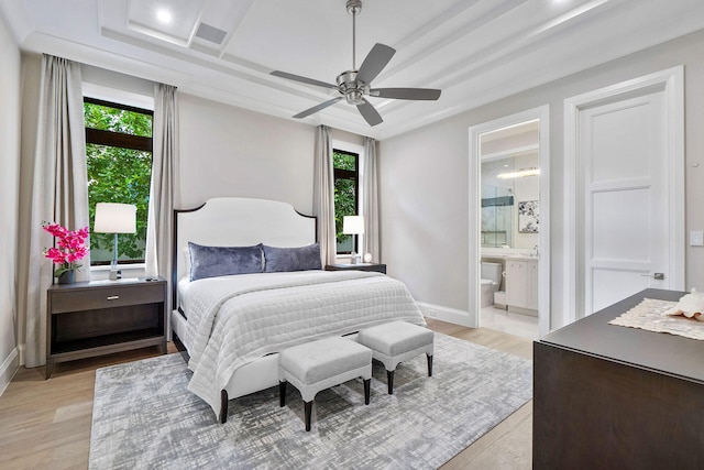 bedroom featuring ensuite bathroom, light hardwood / wood-style flooring, and ceiling fan