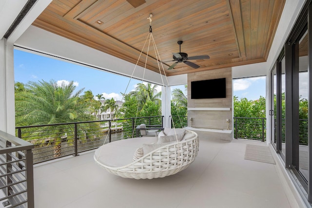 exterior space featuring ceiling fan and wood ceiling