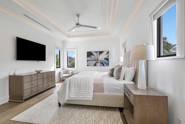 bedroom featuring multiple windows, ceiling fan, light hardwood / wood-style flooring, and ornamental molding