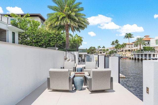 view of patio with a water view and an outdoor fire pit