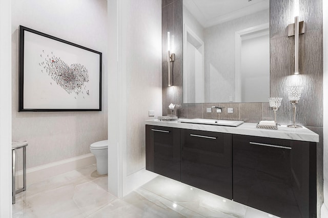 bathroom featuring vanity, toilet, and crown molding