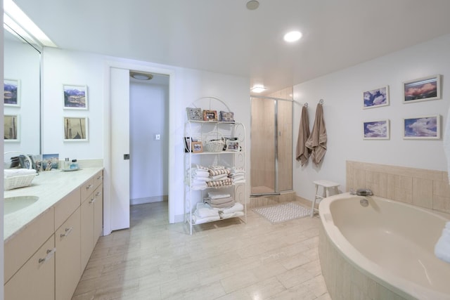 bathroom with vanity and independent shower and bath