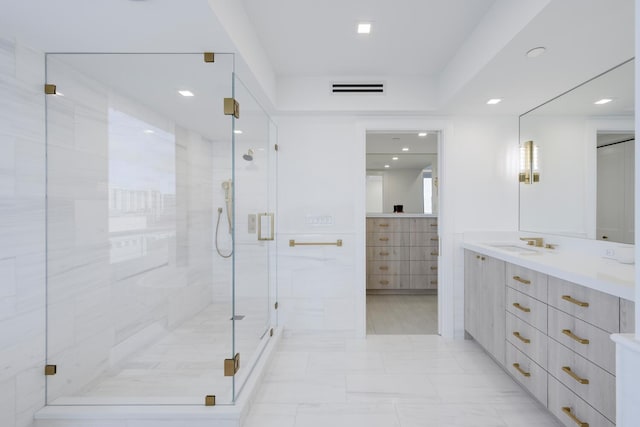 bathroom with vanity and a shower with shower door