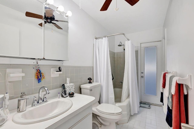 full bathroom with vanity, tile patterned floors, toilet, tile walls, and shower / tub combo with curtain