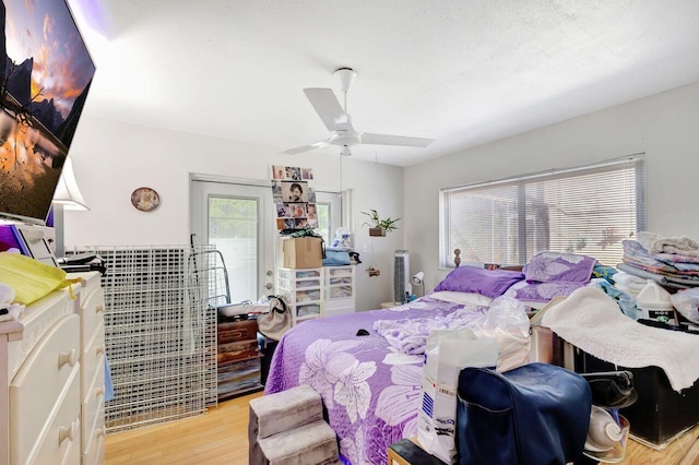 bedroom with light wood-type flooring and ceiling fan