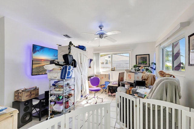 bedroom with ceiling fan and light tile patterned floors