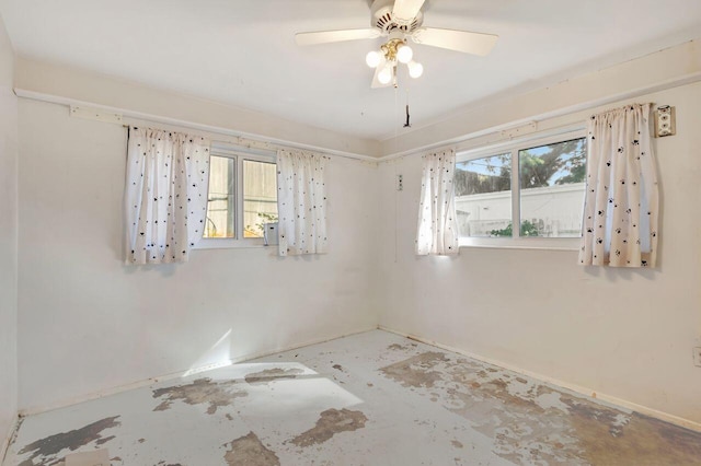 spare room with plenty of natural light and ceiling fan