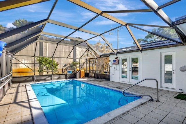 view of pool featuring a lanai, a patio area, and french doors