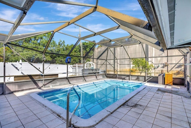 view of pool with a patio and glass enclosure