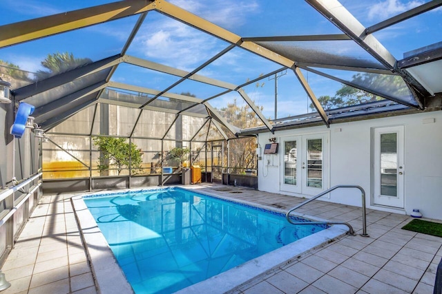 view of swimming pool featuring glass enclosure, a patio, and french doors