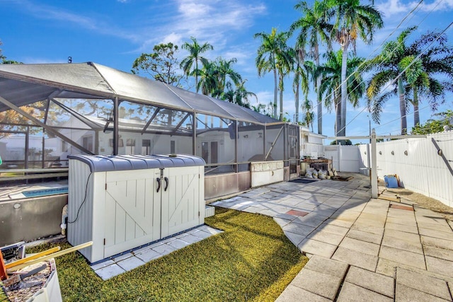 view of patio featuring glass enclosure