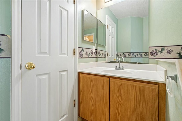 bathroom featuring vanity and a textured ceiling