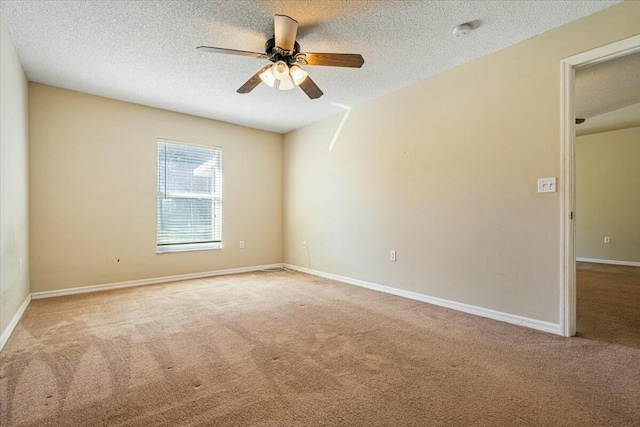 carpeted empty room with a textured ceiling and ceiling fan