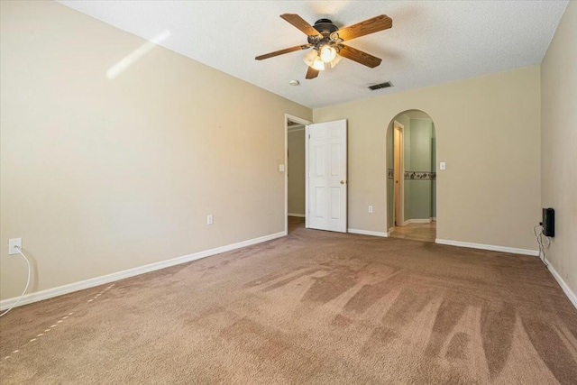 unfurnished bedroom with carpet flooring, a textured ceiling, and ceiling fan