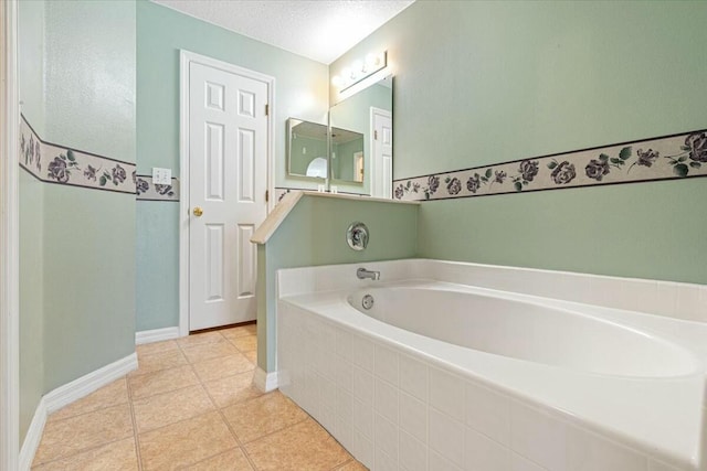 bathroom with tiled tub, tile patterned flooring, and a textured ceiling