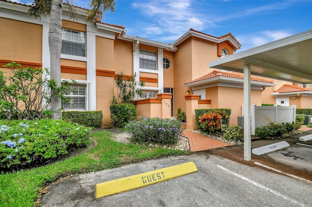 exterior space featuring uncovered parking and fence