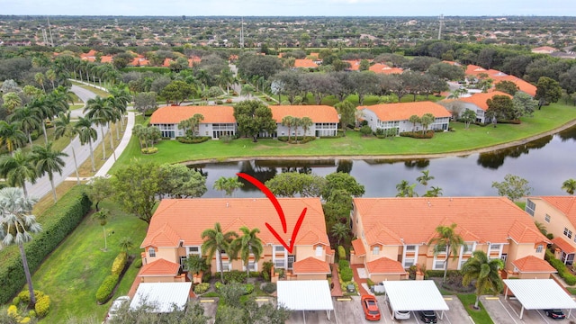 drone / aerial view featuring a residential view and a water view