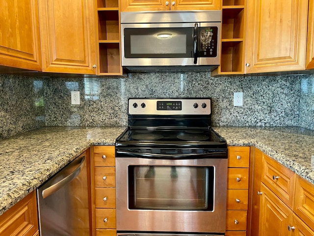 kitchen featuring backsplash, light stone counters, and stainless steel appliances