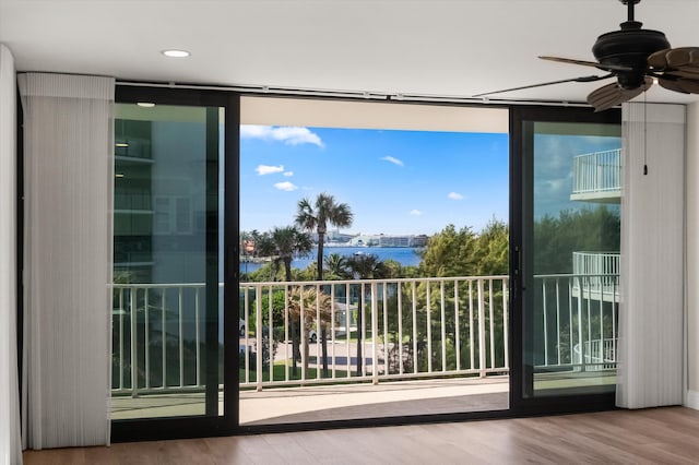 exterior space with a water view and ceiling fan