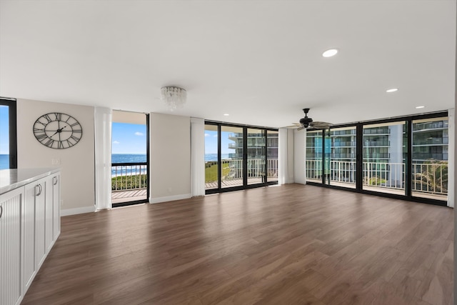 3400 S Ocean Blvd Unit 3Fii, Palm Beach, FL 33480 - unfurnished living room featuring wood finished floors, a ceiling fan, expansive windows, and a water view