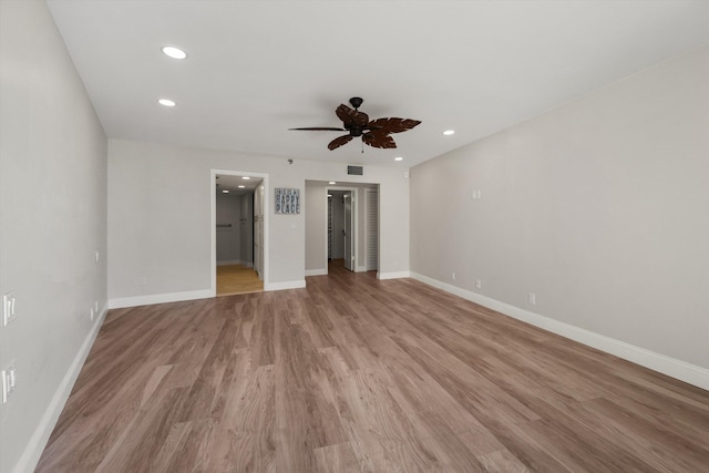 unfurnished bedroom with ceiling fan, ensuite bathroom, and light hardwood / wood-style floors