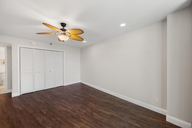 unfurnished bedroom featuring connected bathroom, ceiling fan, a closet, and dark hardwood / wood-style floors